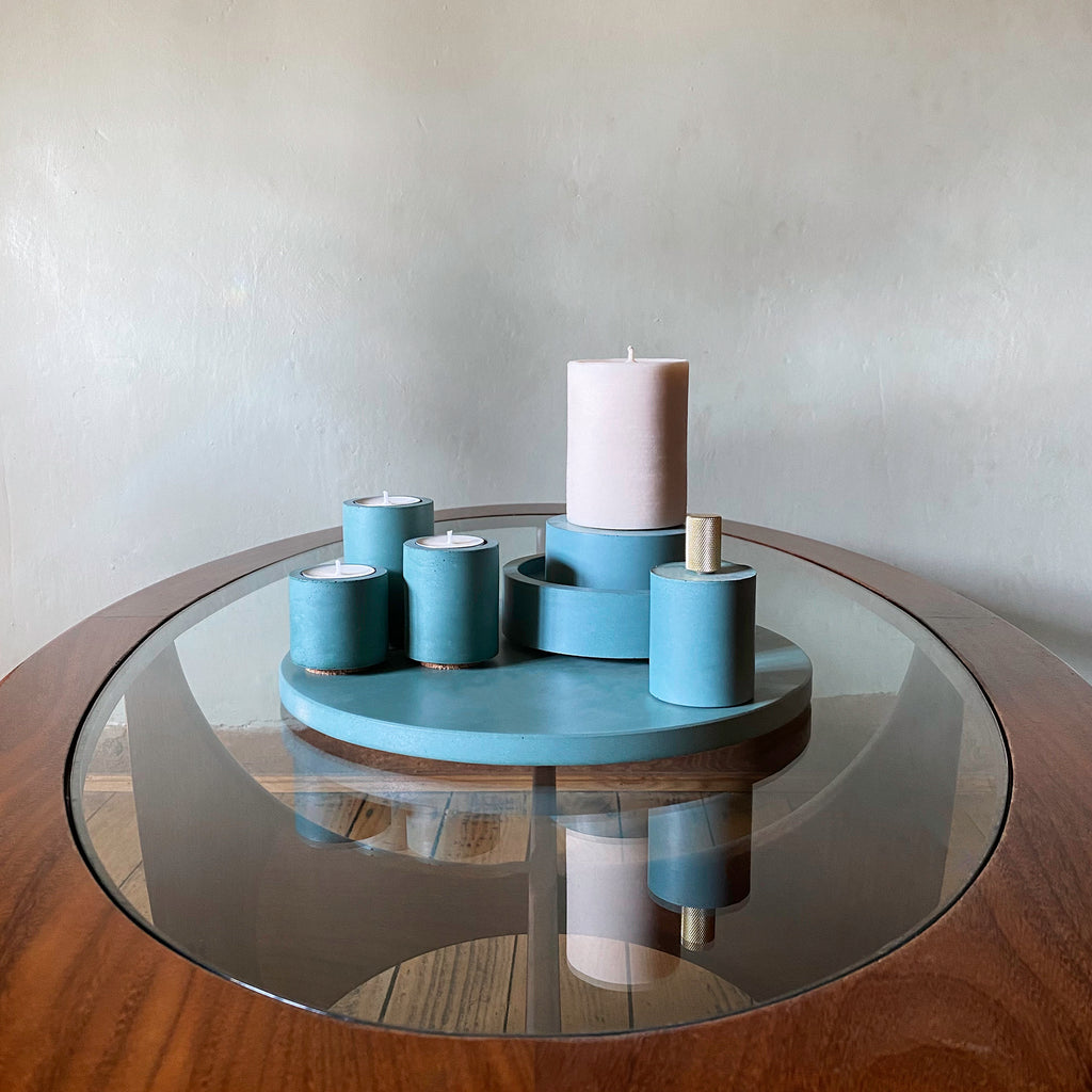 Concrete & Wax Teal Concrete holder, placemat, snuffer and candle coffee table arrangement