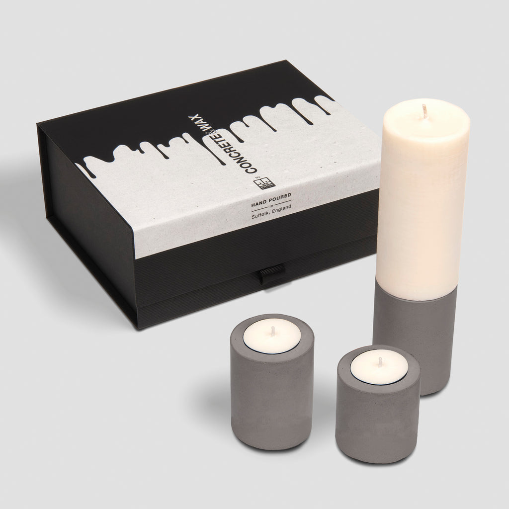 concrete and wax christmas gift box trio of three concrete holders and slim fragranced pillar candle