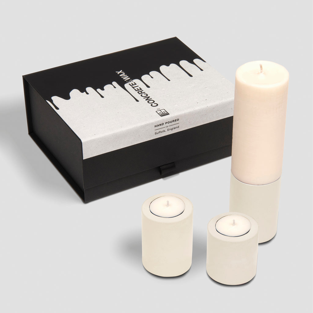 concrete and wax christmas gift box trio of three concrete holders and slim fragranced pillar candle